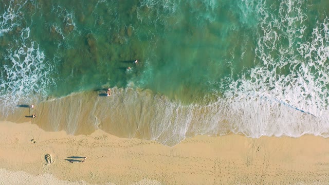SAN JOSE DEL CABO BCS MEXICO-2020: People Swimming in Ocean Waves at Sandy Beach
