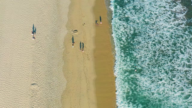 SAN JOSE DEL CABO BCS MEXICO-2020: Beachgoers near Shoreline with Crashing Ocean Waves