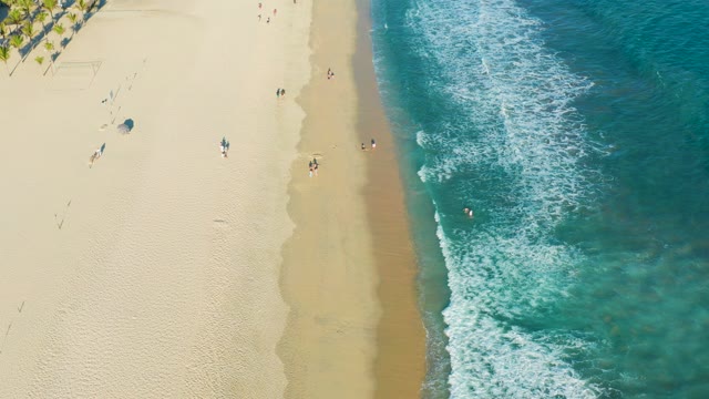 SAN JOSE DEL CABO BCS MEXICO-2020: Beachgoers and Turquoise Waves Along Sandy Shore