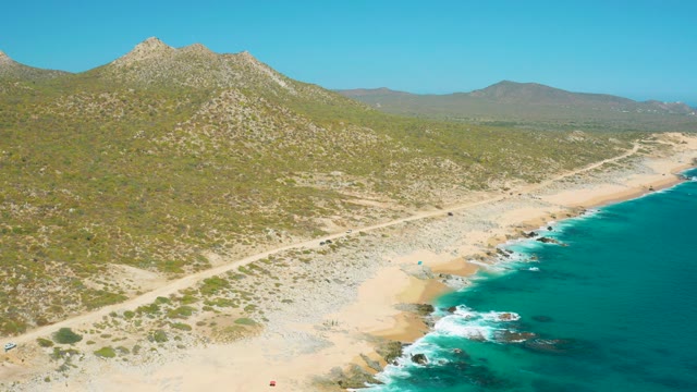 EAST CAPE BCS MEXICO-2020: Coastal Dirt Road with Moving Vehicle and Beachgoers