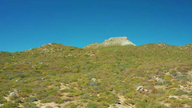 EAST CAPE BCS MEXICO-2020: Hilly Shrubland with Clear Blue Sky and Rocky Outcrops
