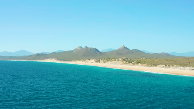 EAST CAPE BCS MEXICO-2020: Sandy Beach Bordered by Turquoise Ocean and Distant Mountains