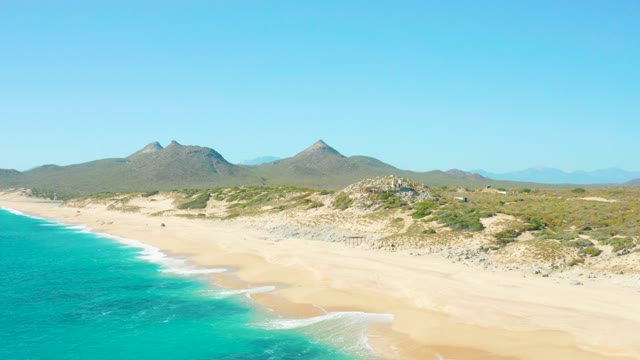 EAST CAPE BCS MEXICO-2020: Gentle Ocean Waves Lapping Sandy Shore with Distant Mountains