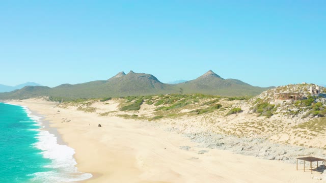 EAST CAPE BCS MEXICO-2020: Person Walking Along Sandy Beach with Mountain Backdrop