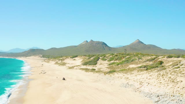 EAST CAPE BCS MEXICO-2020: Sandy Beach with Dunes and People Moving Along Shore