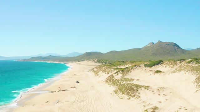 EAST CAPE BCS MEXICO-2020: Vehicle Moving Along Sandy Beach with Turquoise Ocean