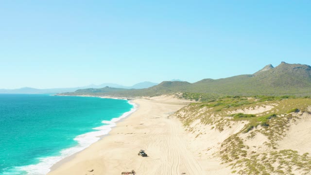 EAST CAPE BCS MEXICO-2020: Vehicle Traveling Along Sandy Beach with Turquoise Ocean
