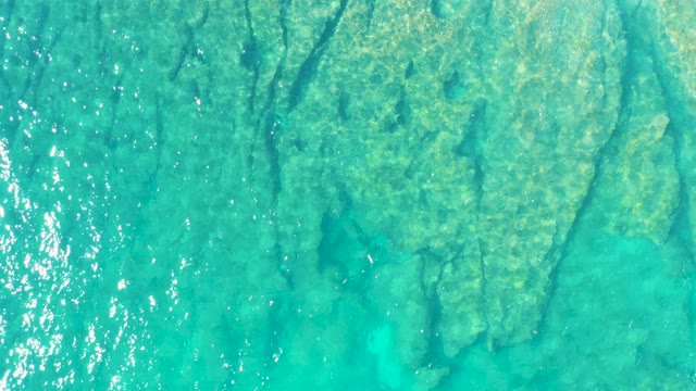 Turquoise Ocean Water with Visible Seabed and Gentle Ripples