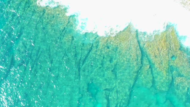 Clear Turquoise Ocean Waves with Visible Seabed