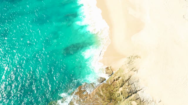 Turquoise Ocean Waves Crashing on Rocky Shore