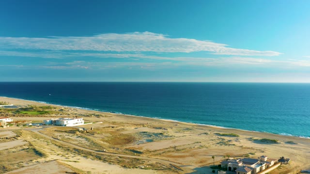 Coastal Dunes and Beach with Structures Moving Out of Frame