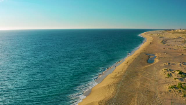 Gentle Waves Lapping Sandy Shoreline