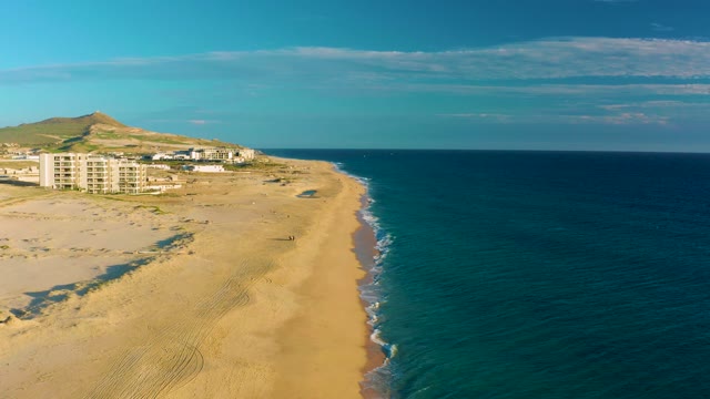 Sandy Beach with Person Walking Along Shore