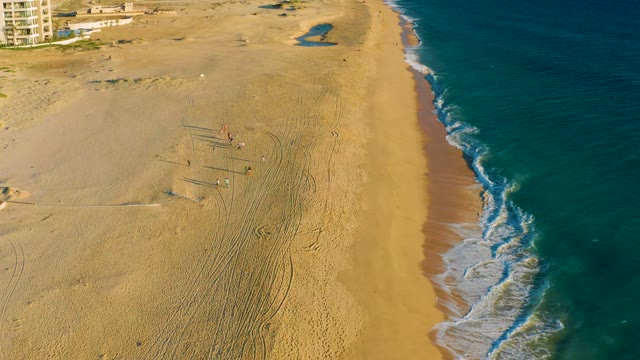 Sandy Beach with People and Ocean Waves