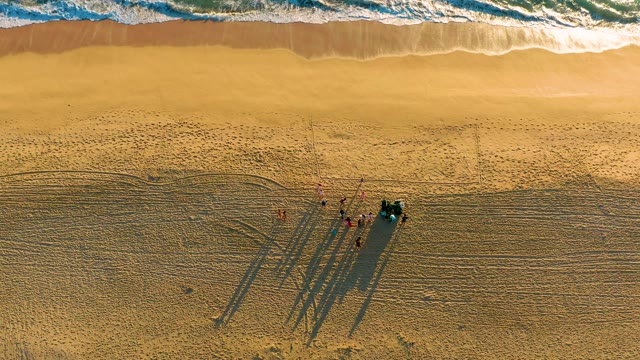 Beach Workers and Vehicle with Ocean Waves