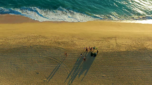 Beachgoers and Advancing Ocean Waves