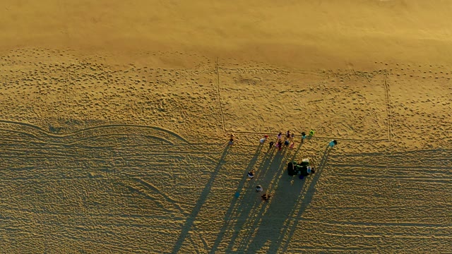 Group of People Towed by Dune Buggy on Sandy Beach