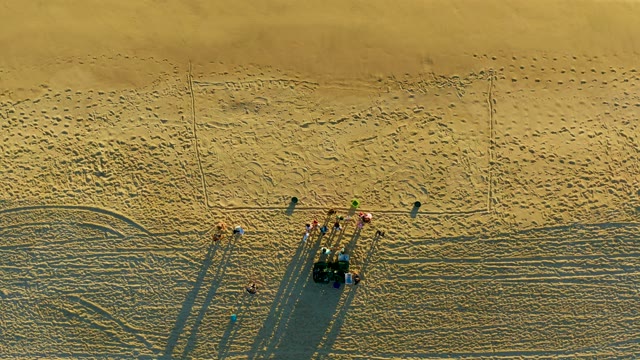 Beach Maintenance Crew Moving Across Sand