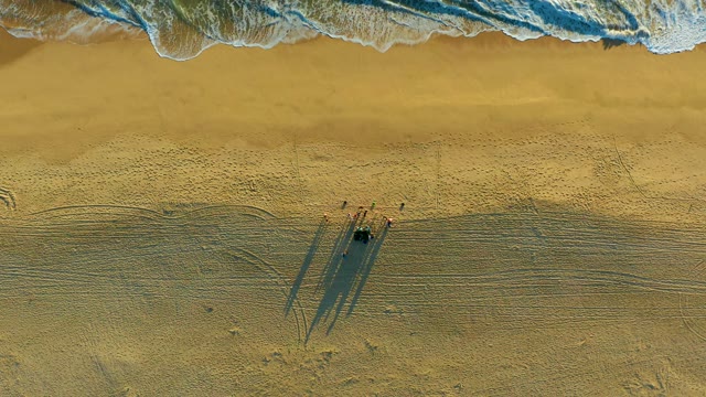 Beachgoers and Receding Ocean Waves From Above