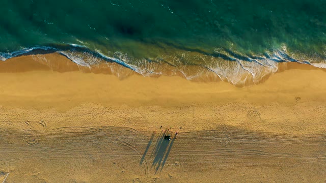 Waves Rolling Onto Golden Sandy Beach