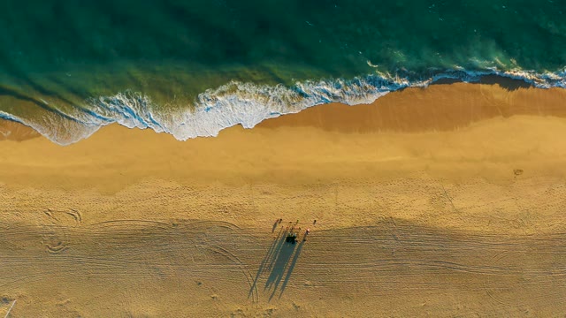 Waves Advancing on Sandy Beach From Overhead