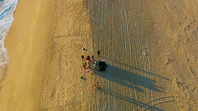 Beachgoers Socializing As Ocean Recedes