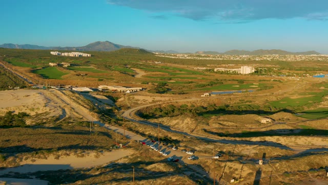 Vehicles Moving on Arid Road From Aerial Perspective