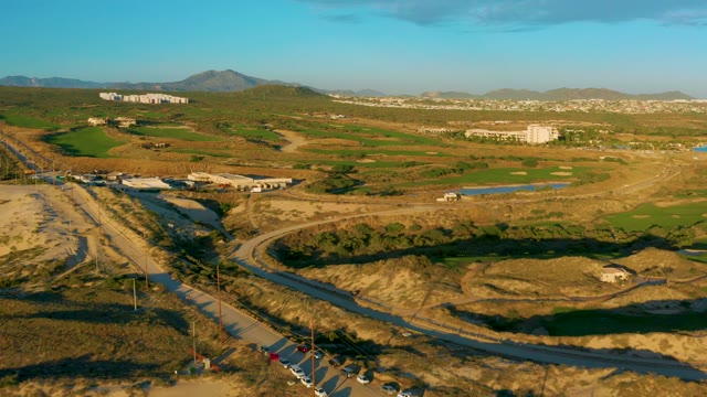 Vehicles Traveling on a Winding Road in Arid Fields