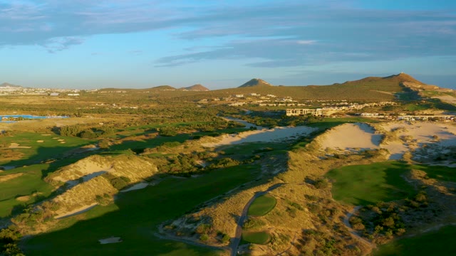 Golf Course and Sandy Dunes with Distant Hills