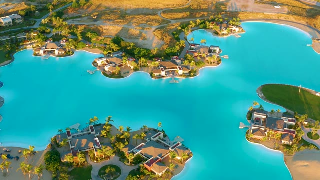 Lagoon with Waterfront Villas and Shifting Water Hues