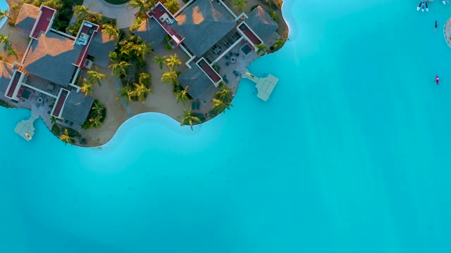 Coastal Resort Buildings and Turquoise Shoreline From Above