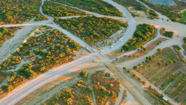 Vehicles Navigating a Rural Road Intersection