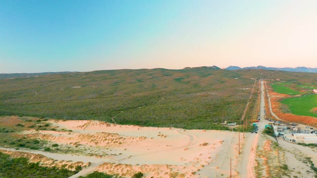 DIAMANTE CABO SAN LUCAS BCS MEXICO-2020: Vehicles Traveling on a Rural Road Through Hilly Terrain