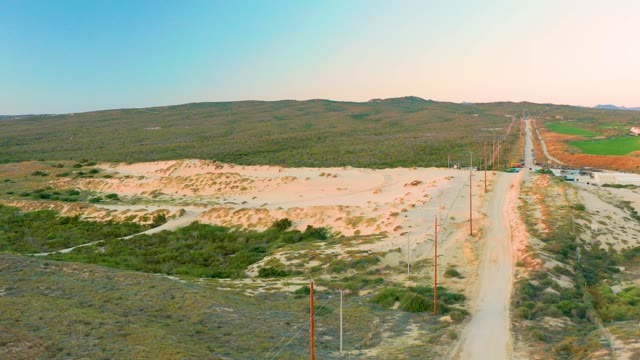 DIAMANTE CABO SAN LUCAS BCS MEXICO-2020: Rural Dirt Road with Utility Poles and Rolling Hills