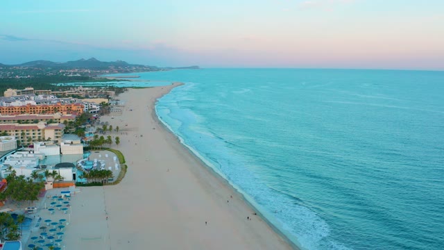 SAN JOSE DEL CABO BCS MEXICO-2020: Gentle Waves Lapping a Sandy Beach with Coastal Buildings