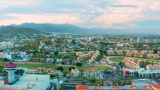 SAN JOSE DEL CABO BCS MEXICO-2020: Aerial Pan over City with Green Field and Mountains