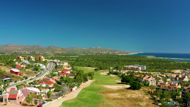 SAN JOSE DEL CABO BCS MEXICO-2020: Vehicles Moving on Road near Golf Course and Homes