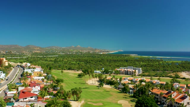 SAN JOSE DEL CABO BCS MEXICO-2020: Vehicles Traveling Along Coastal Road near Golf Course