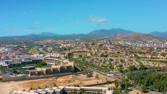 SAN JOSE DEL CABO BCS MEXICO-2020: Cityscape with Mountain Backdrop and Moving Traffic