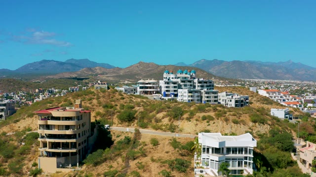 SAN JOSE DEL CABO BCS MEXICO-2020: Hillside Residential Buildings and Passing Car