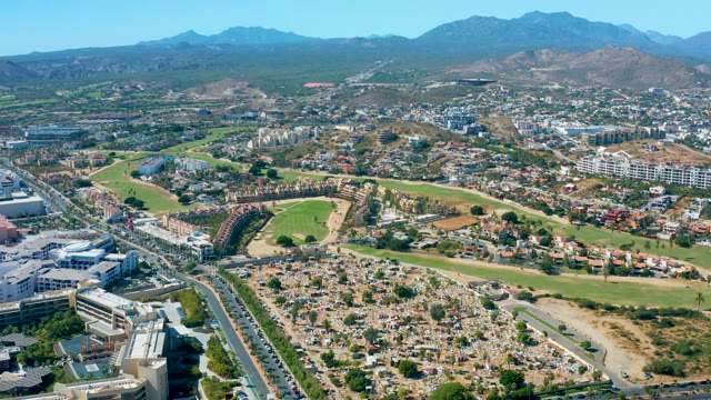 SAN JOSE DEL CABO BCS MEXICO-2020: City Traffic Moving Past Residential Area and Green Fields