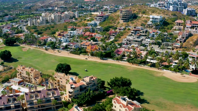 SAN JOSE DEL CABO BCS MEXICO-2020: Golf Cart Moving Across Residential Green Space