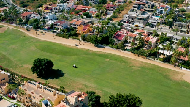 SAN JOSE DEL CABO BCS MEXICO-2020: Golf Cart Moving Across Residential Green Space