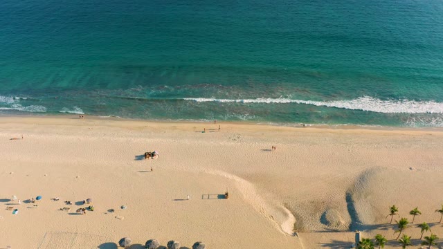 SAN JOSE DEL CABO BCS MEXICO-2020: Beachgoers and Ocean Waves on a Sandy Shore
