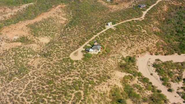 CABO PULMO BCS MEXICO-2020: Person Walking on a Dirt Road Through Hilly Terrain