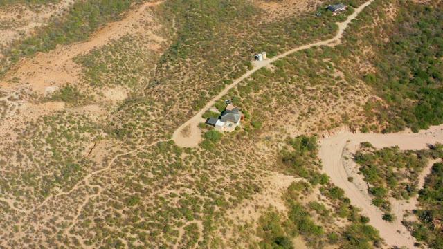 CABO PULMO BCS MEXICO-2020: Vehicle Moving Along a Winding Dirt Road in Arid Hills