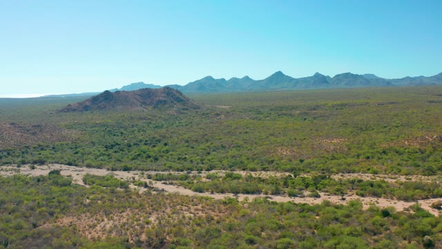 CABO PULMO BCS MEXICO-2020: Arid Terrain with Distant Mountain Ranges and Sparse Vegetation