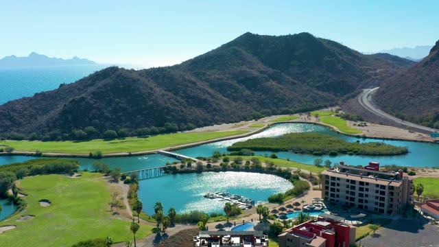LORETO BCS MEXICO-2020: Vehicles Moving on Road Near Lake and Golf Course