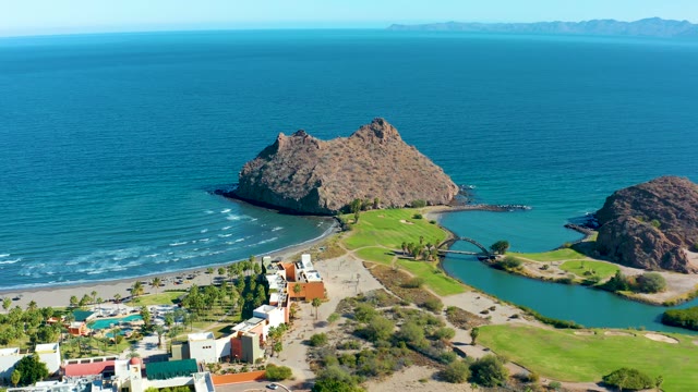 LORETO BCS MEXICO-2020: Beach with Moving Vehicles and Rocky Ocean Outcrop