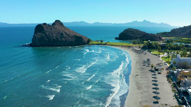 LORETO BCS MEXICO-2020: Sandy Beach with Rolling Waves and Rocky Outcrop